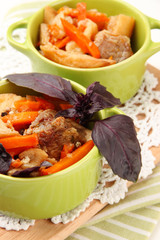 Homemade beef stir fry with vegetables in color pans, isolated