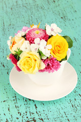 Beautiful bouquet of bright flowers in color vase,