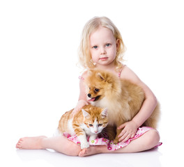 Fototapeta na wymiar girl playing with pets - dog and cat. looking at camera.isolated