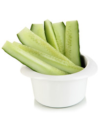Bright fresh cucumber cut up slices in bowl isolated on white