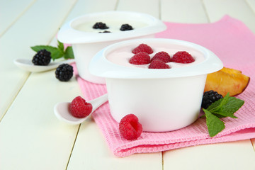 Delicious yogurt with fruit and berries on table close-up