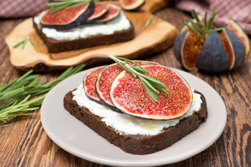 bread with goat cheese, figs, honey and rosemary on a plate