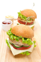 chicken burger with vegetables, cheese, ketchup, mustard