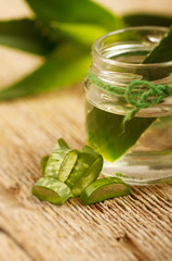 Extract of organic aloe vera gel on wooden background