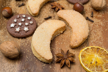 Obraz na płótnie Canvas Christmas cookies, spices and nuts on a wooden background