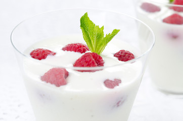 close-up of panna cotta with fresh raspberries horizontal