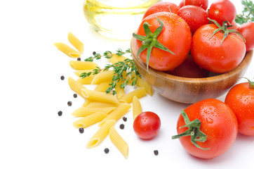 fresh tomatoes, penne pasta, spaghetti and spices on white