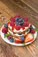 Pancake cake with whipped cream and fresh berries
