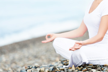 hand of  woman meditating in a yoga pose on beach