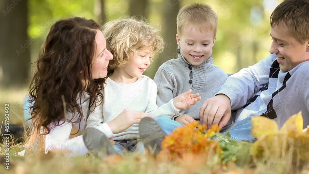 Poster Happy family playing outdoors in autumn park. Dolly shot