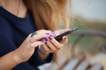 Close up of a girl using mobile smart phone