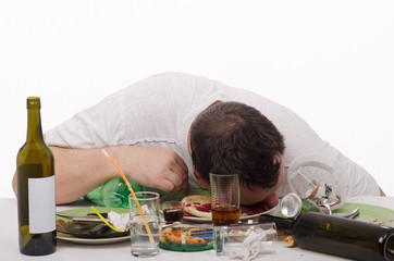 Drinker put his head in a plate with leavings