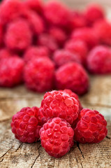 Fresh, organic raspberry on wood background