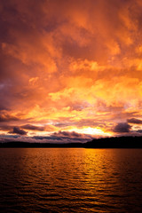 Obraz premium Dramatic fire red sunset over a lake
