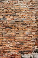 Old orange cracked brick wall