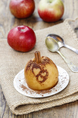Naklejka na ściany i meble Baked apple decorated with cinnamon heart shape ornament