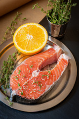 Raw salmon steak with orange and thyme