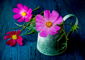 Flowers in a jar in a vintage style on a blue background