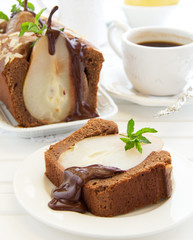 Chocolate cake with pears and chocolate sauce.