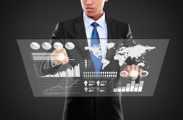 man pushing on a touch screen of infographics