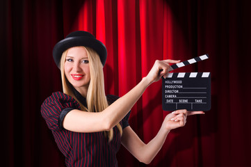 Woman gangster with movie clapper