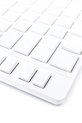 Closeup of a computer keyboard with blank keys. White keyboard i