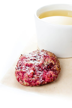 Raspberry cookie with oatmeal and cup of green tea on  white bac