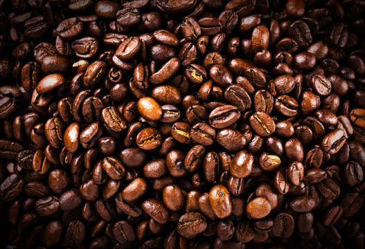 Roasted brown coffee beans  background or texture closeup. High