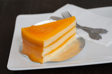 Orange cake on white dish at coffee shop