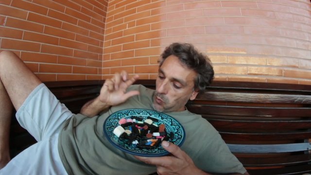 man eating candies