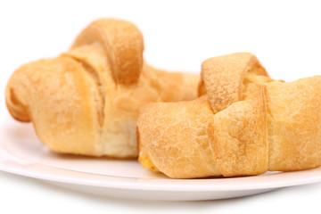 fresh croissants on white plate