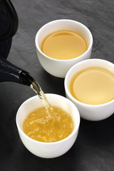 Green tea being poured into cups
