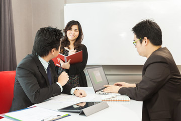 Young business people are working in the meeting room.
