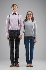Nerd couple. Full length of happy nerd couple standing isolated