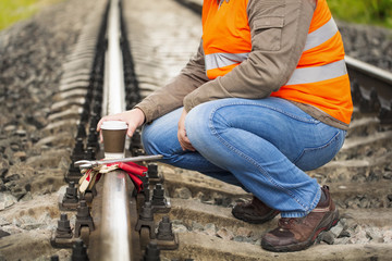 Worker with a coffee on the rail in summer