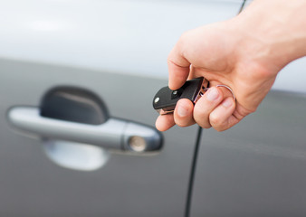 man with car key outside