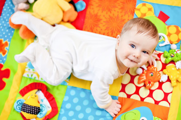 Infant boy on playmat