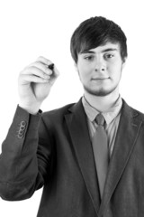 Young businessman with pen on the blackboard