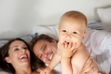 Portrait of a happy family laughing with baby