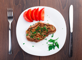 Grilled steak on white plate