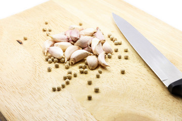 Group of garlics and peppers with knife
