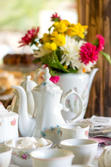 Vintage porcelain tea cups decoration and colorful flowers