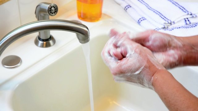 Washing hands under a faucet