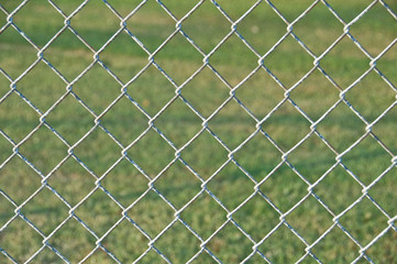 Fototapeta premium chain link fence with grass background