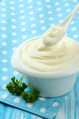 Sour cream in bowl on table close-up