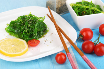 Sea kale on plate on wooden table close-up