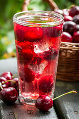 Fototapeta na wymiar Close-up of sweet cherries juice with ice cubes