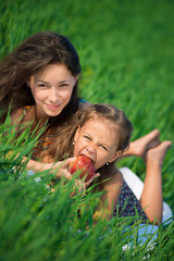 Happy girls on green grass with apple © mr.markin