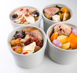 Chicken and herb soup in pot, Chinese food style.