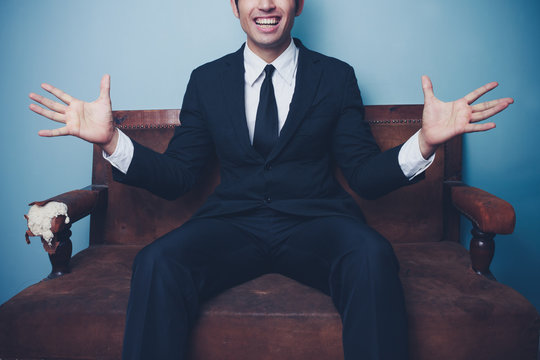 Excited young businessman on sofa